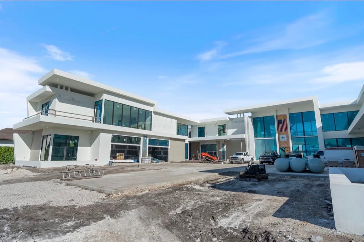 Luxury modern home construction with white stucco exterior